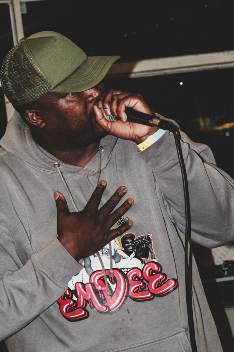 Performer with hand on chest, mic in hand