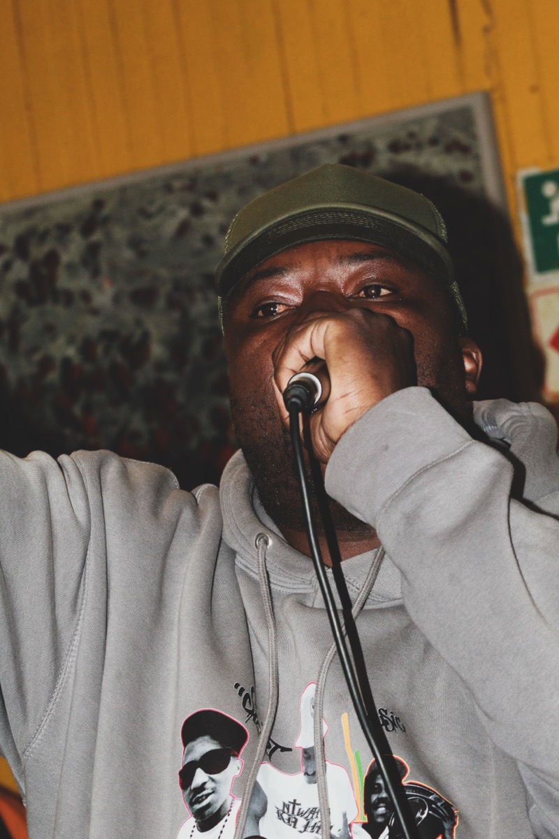 Performer on the mic at Native Rebels