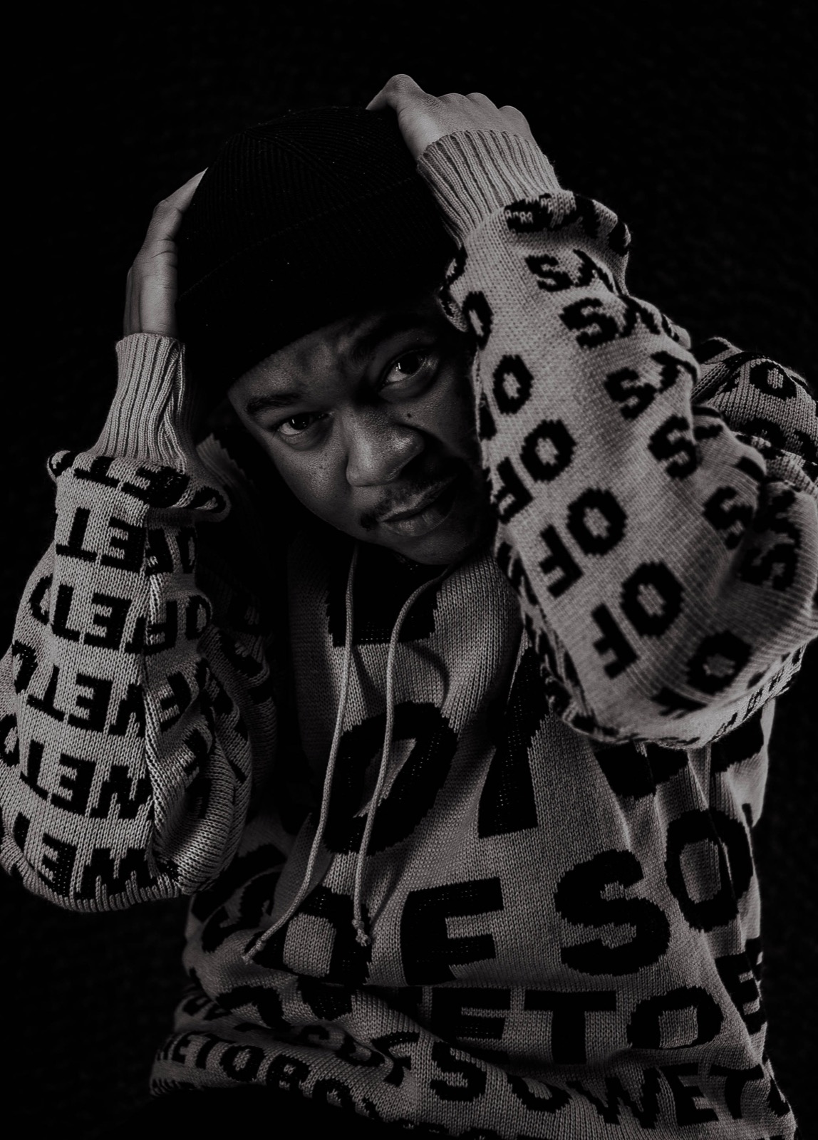 Mthizo in black and white, hands over head