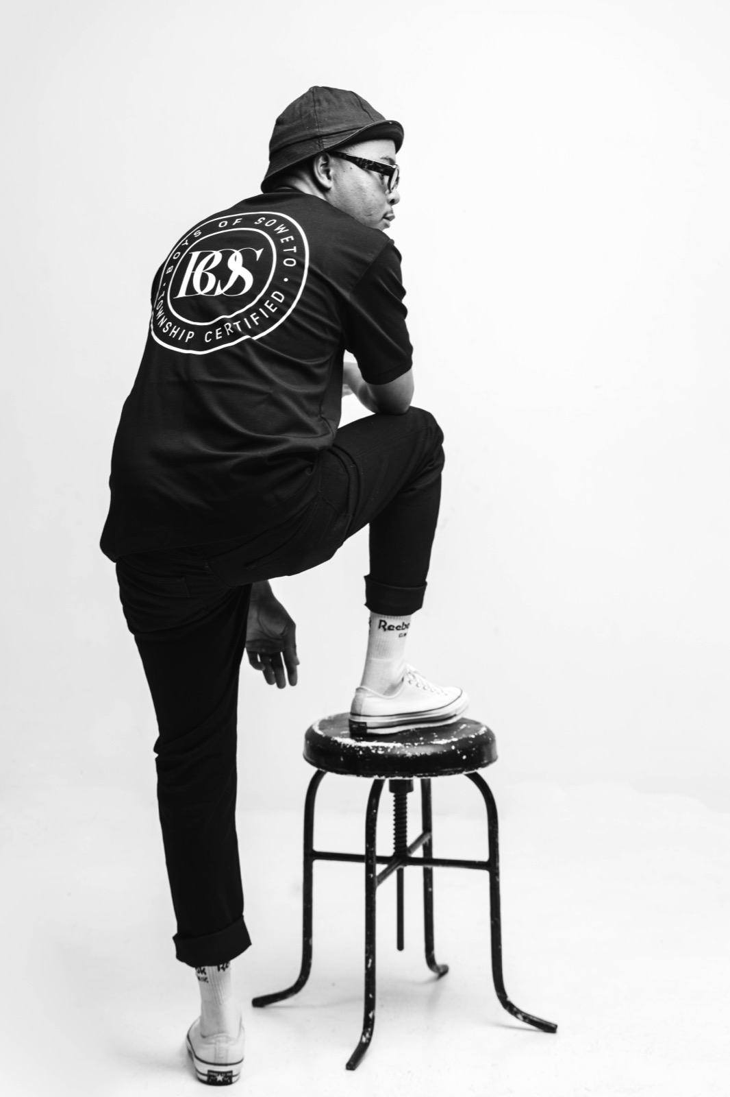 Mthizo in black and white with one foot on a stool